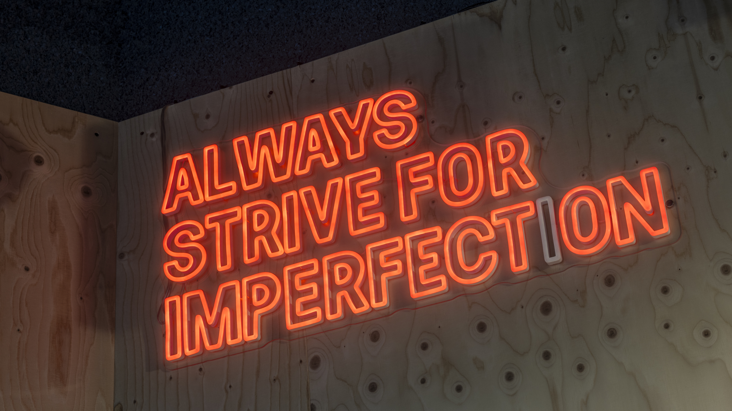 Red glowing neon signs with one of includi's famous quote.